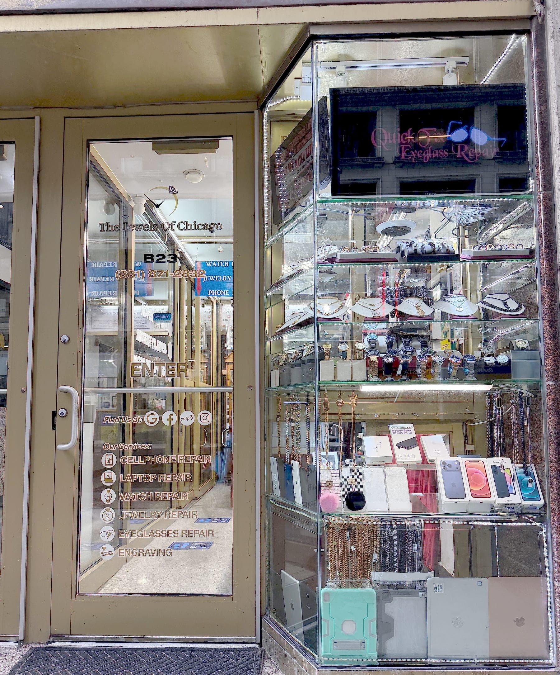 The shop's brass storefront on East Madison Street: a glass door listing the repairs offered, beside a lit display case of watches, chains and phone accessories.